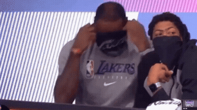 Man In Lakers Shirt Sitting With Masked Man GIF