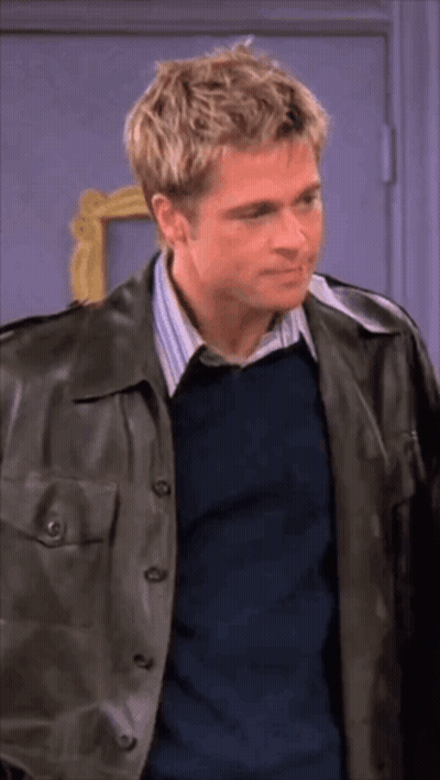 Man In Leather Jacket And Blue Shirt Standing Before Door GIF