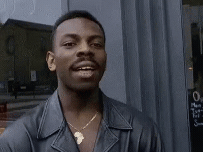 Man In Leather Jacket And Necklace Smiling GIF