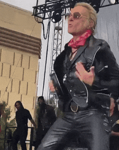 Man In Leather Jacket And Sunglasses Dancing On Stage GIF