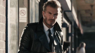 Man In Leather Jacket And Tie At No Smoking Sign GIF