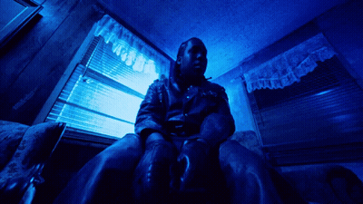 Man In Leather Jacket At Blue Window GIF