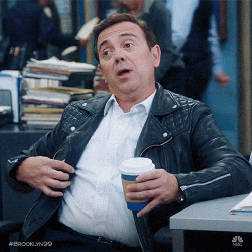 Man In Leather Jacket At Desk Holding Coffee With #Brooklyn99 GIF