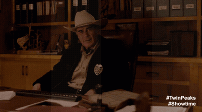 Man In Leather Jacket At Desk Saying In The Flesh GIF