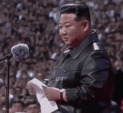 Man In Leather Jacket At Microphone Holding Paper GIF