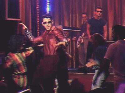 Man In Leather Jacket Dancing In Dark Room GIF