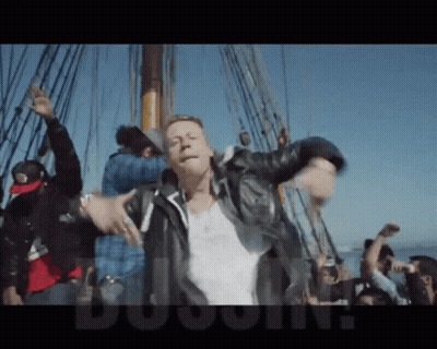 Man In Leather Jacket Dancing On Boat With Crowd Dugout GIF