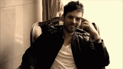 Man In Leather Jacket Hand To Forehead GIF
