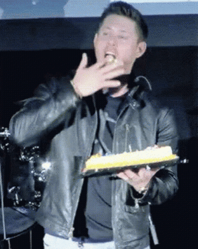 Man In Leather Jacket Holding Birthday Cake GIF