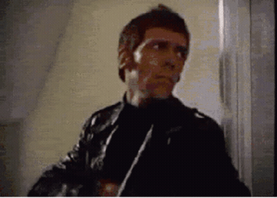 Man In Leather Jacket Holding Knife GIF
