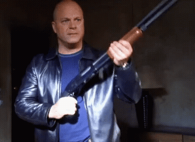 Man In Leather Jacket Holding Shotgun GIF