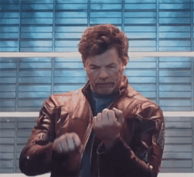 Man In Leather Jacket In Front Of Blue Wall GIF