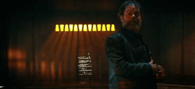 Man In Leather Jacket In Front Of True Captain Sign GIF