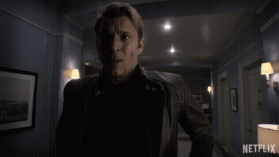 Man In Leather Jacket In Hallway With Netflix GIF