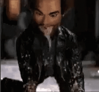 Man In Leather Jacket Kneeling And Eating GIF