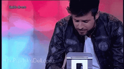 Man In Leather Jacket Looking At Sonido Directo Screen GIF