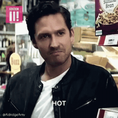 Man In Leather Jacket Making Face In Grocery Store GIF