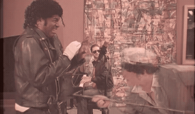 Man In Leather Jacket Next To Man In White Hat GIF