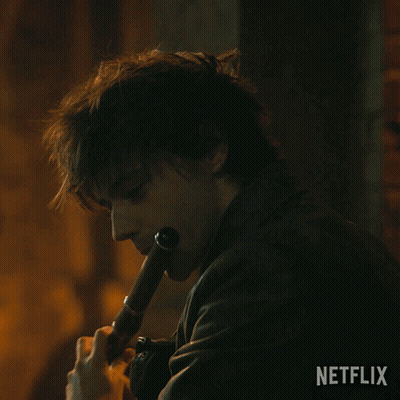 Man In Leather Jacket Playing Flute With Netflix Logo GIF