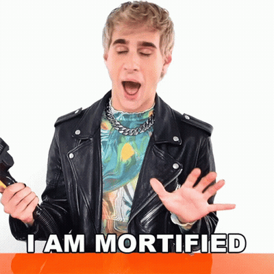 Man In Leather Jacket Says I Am Mortified Holding Microphone GIF