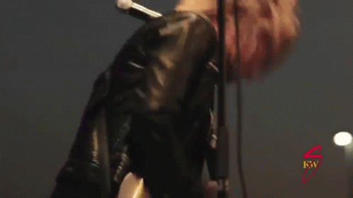 Man In Leather Jacket Singing And Playing Guitar GIF