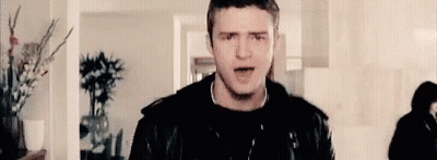 Man In Leather Jacket Singing Into Microphone GIF
