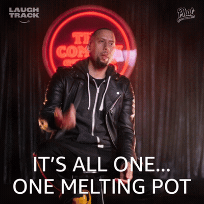 Man In Leather Jacket Sitting In Front Of It's All One Melting Pot Sign GIF