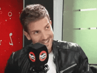 Man In Leather Jacket Smiling Holding Radio Disney Microphone GIF