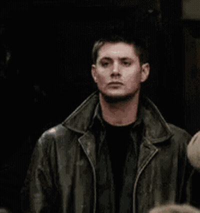 Man In Leather Jacket Standing Beside Another Man GIF