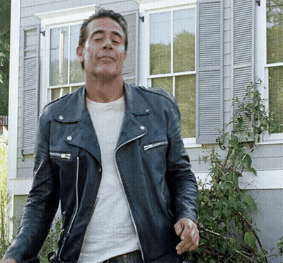 Man In Leather Jacket Standing In Front Of Building GIF