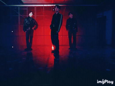 Man In Leather Jacket Standing Next To Two Men GIF