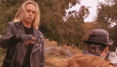 Man In Leather Jacket Talking To Man In Hat GIF