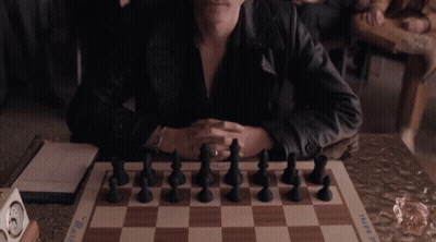 Man In Leather Jacket With Chess Board GIF