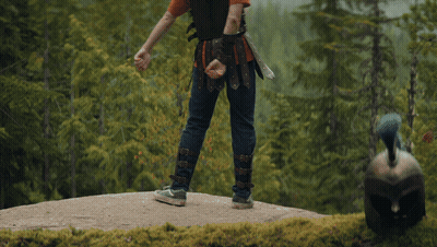 Man In Leather Vest Standing In Woods GIF