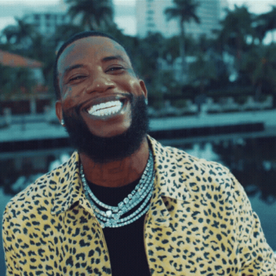 Man In Leopard Print Shirt And Necklaces Smiling GIF