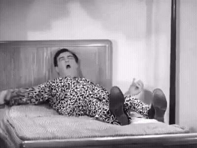 Man In Leopard Print Shirt Lying On Bed GIF