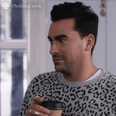 Man In Leopard Print Sweater Holding Coffee GIF