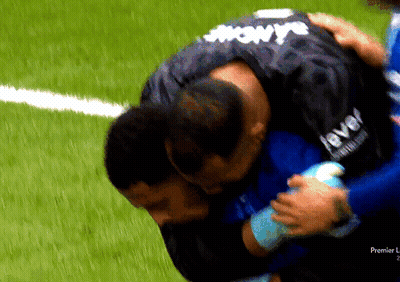 Man In Level Jersey Hugging Another On Soccer Field GIF