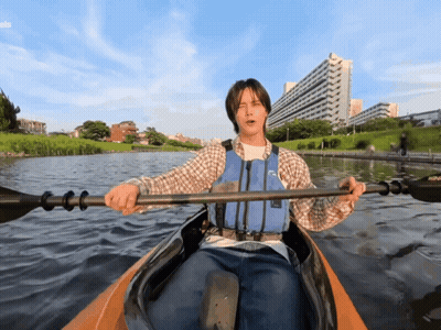 Man In Life Vest Paddling Kayak On Lake GIF