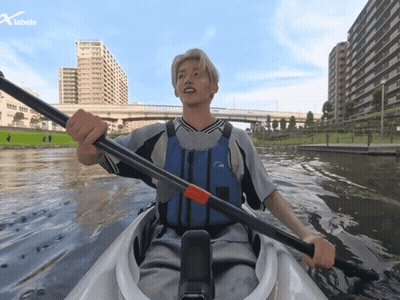 Man In Life Vest Paddling Kayak With X Labels Logo GIF