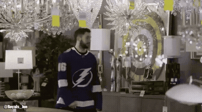 Man In Lightning Bolt Jersey Standing In Store GIF