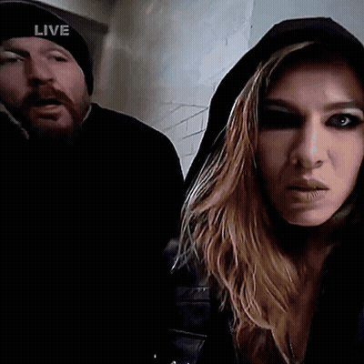 Man In Live Hat Next To Hooded Woman GIF