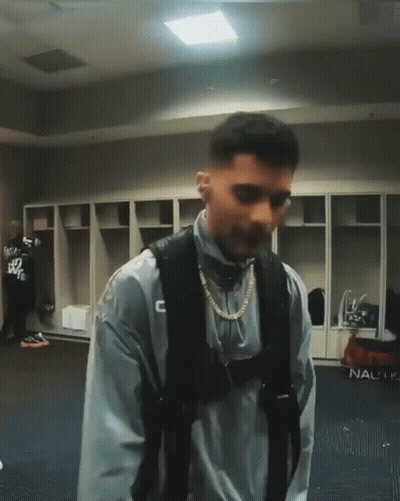 Man In Locker Room With C Sweatshirt GIF
