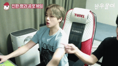 Man In Loewe Shirt Sitting In Twins Chair GIF
