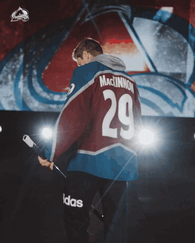 Man In MacKinnon 29 Jersey Holding Hockey Stick GIF