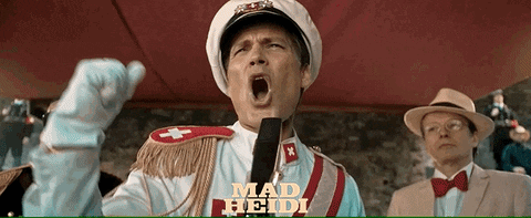 Man In Mad Heidi Costume Yelling Into Microphone GIF