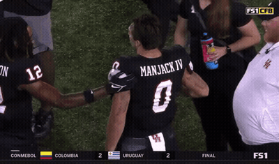 Man In Manjack IV Jersey Talking To Another Man GIF
