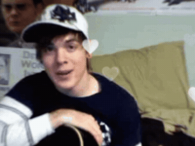 Man In Maple Leafs Hat Looking At Camera GIF