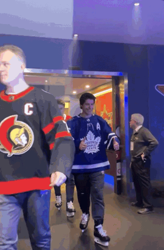 Man In Maple Leafs Jersey Walking GIF
