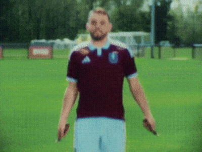 Man In Maroon Adidas Shirt On Green Field GIF